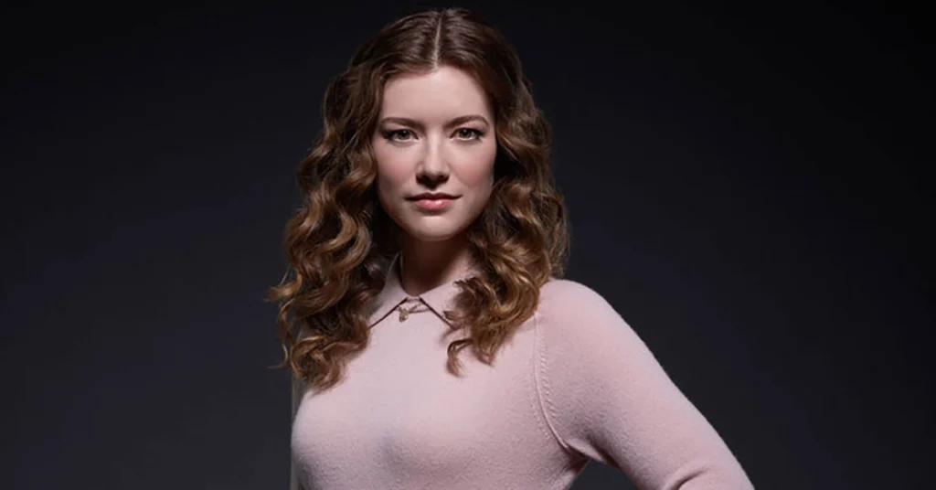 Molly Kunz portrait in a pink sweater, showcasing her fit physique and confident stance, highlighting her approach to weight and fitness in Hollywood