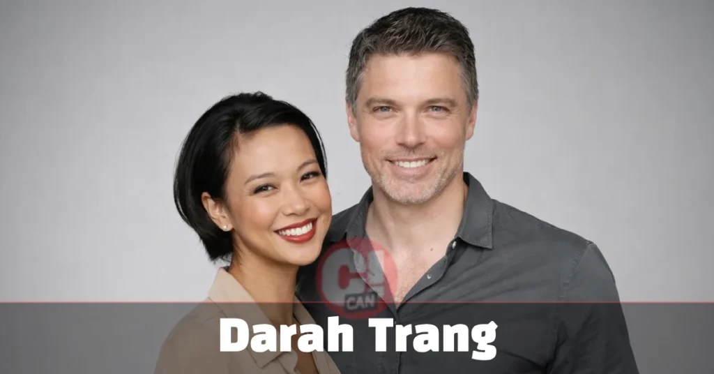 Darah Trang smiling at a red carpet event with husband Anson Mount, dressed in formal wear at a Hollywood premiere.