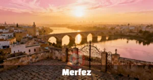 Historic Merfez old quarter with stone alleys, an arched bridge, and a riverside promenade at sunset — top travel destination 2026.