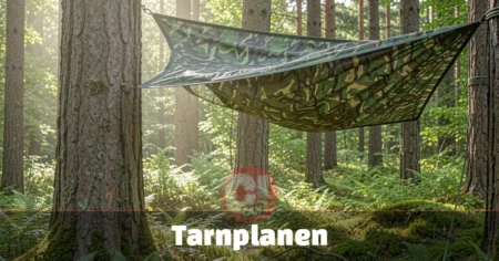 Tarnplanen camouflage tarp set up as forest shelter between pine trees using paracord and metal grommets.